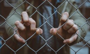 chain link fence and hands